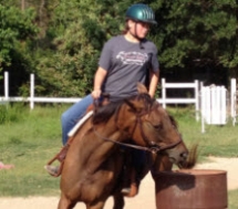 Emily learning barrel racing on Ginger